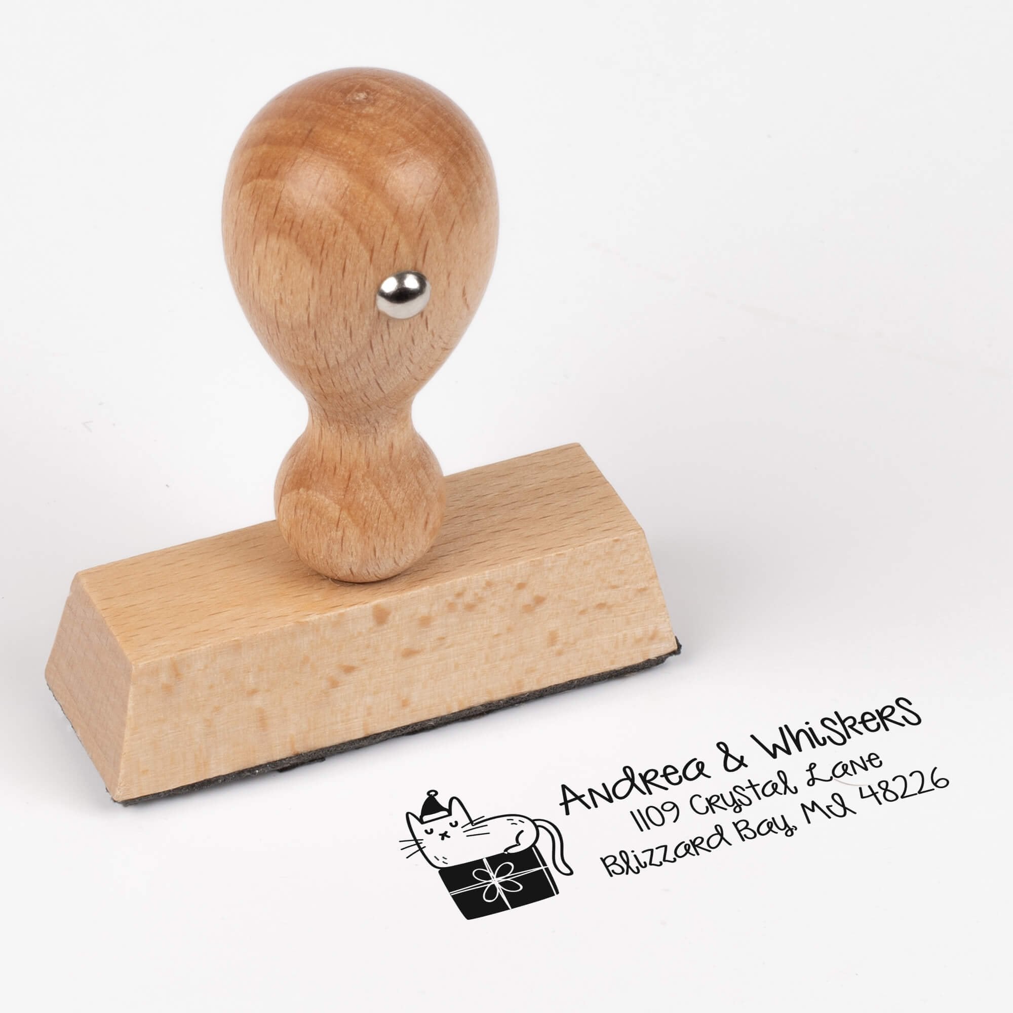 European wood hand stamp shown from above featuring custom ‘Holiday Cat’ holiday return address design.