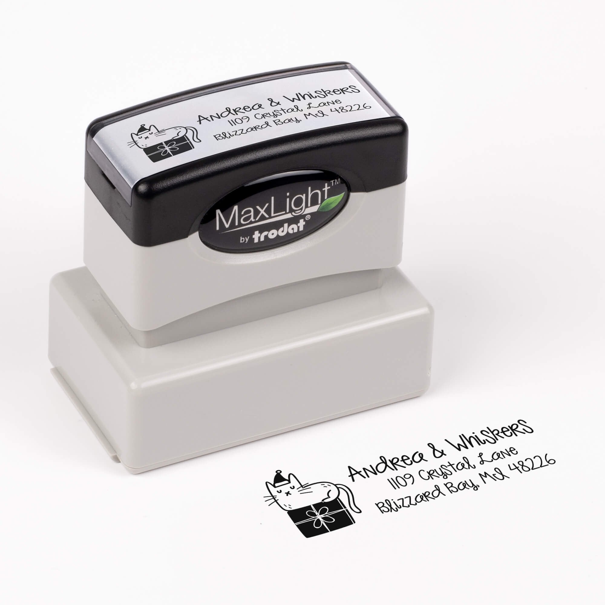 Pre-inked stamp shown from above featuring custom ‘Holiday Cat’  holiday return address design.