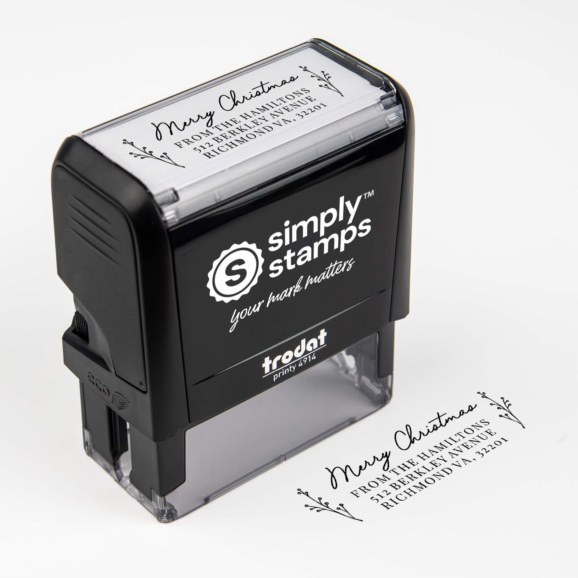 Top angle view of self-inking holiday stamp with circular ‘Merry Christmas Sprig’ address design.