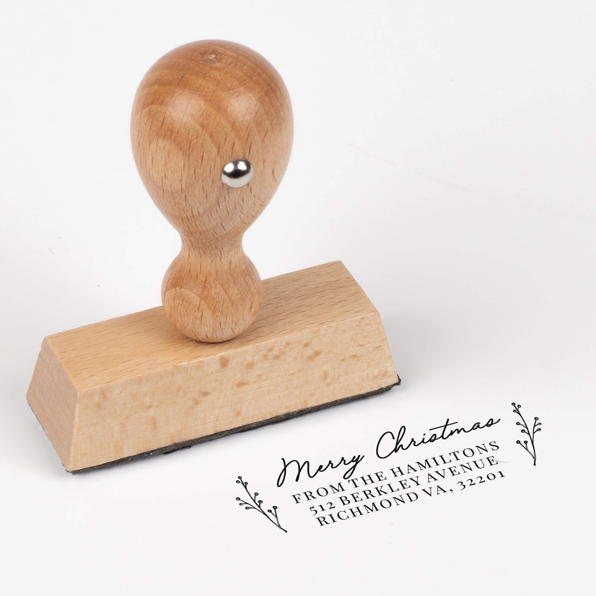 European wood hand stamp shown from above featuring custom ‘Merry Christmas Sprig’ holiday return address design.