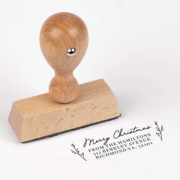 European wood hand stamp shown from above featuring custom ‘Merry Christmas Sprig’ holiday return address design.