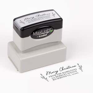 Pre-inked stamp shown from above featuring custom ‘Merry Christmas Sprig’  holiday return address design.