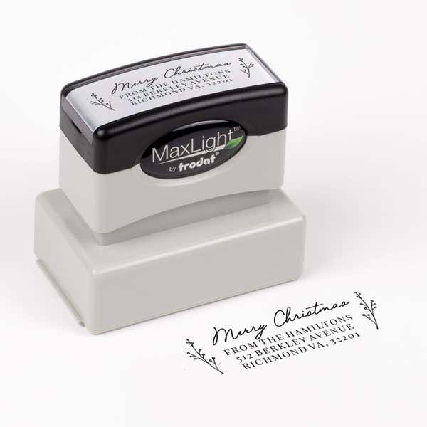 Pre-inked stamp shown from above featuring custom ‘Merry Christmas Sprig’  holiday return address design.