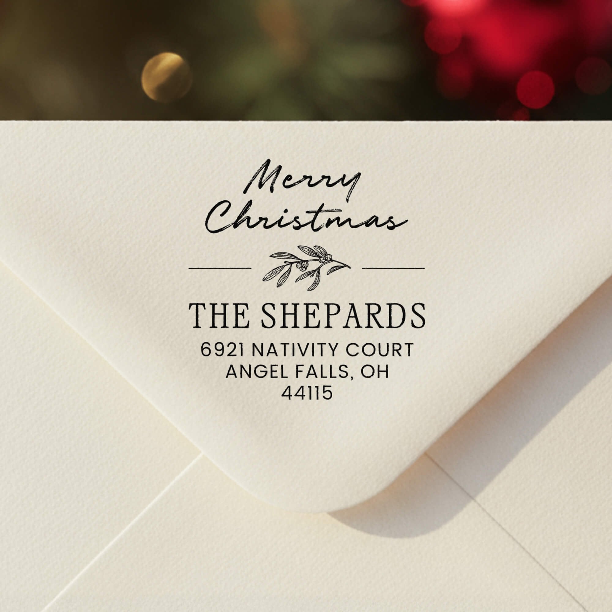 Personalized ‘Magnolia Merry Christmas’ address stamp impression on envelope flap for holiday cards.