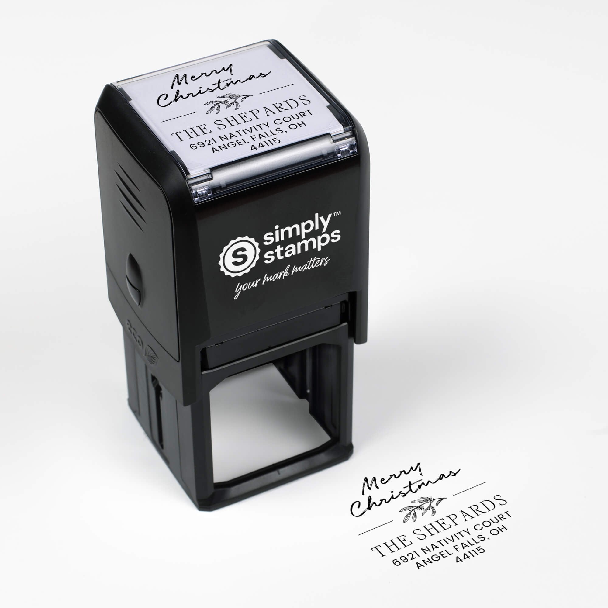 Top angle view of self-inking holiday stamp with circular ‘Magnolia Merry Christmas’ address design.