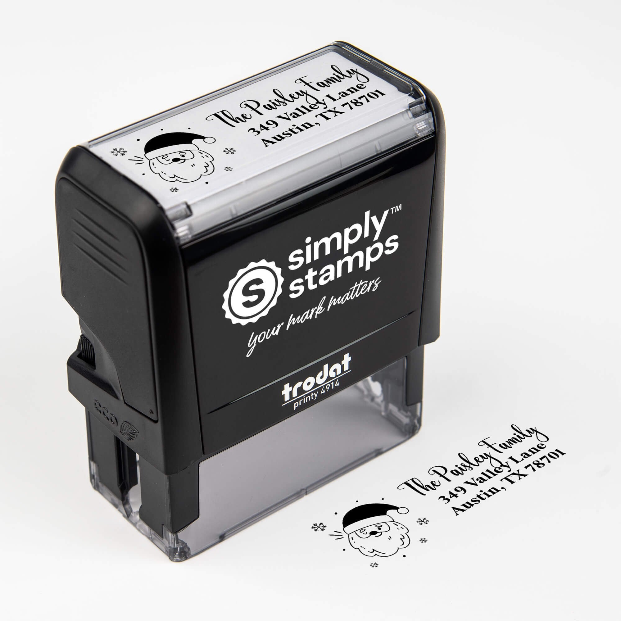 Top angle view of self-inking holiday stamp with circular ‘Santa Claus’ address design.