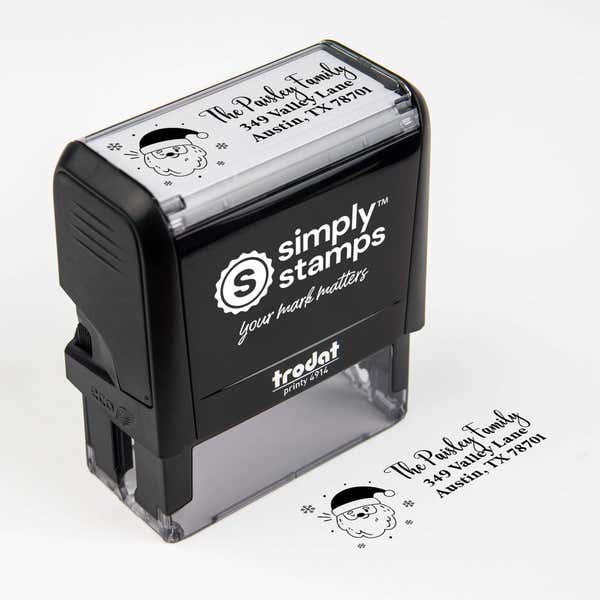 Top angle view of self-inking holiday stamp with circular ‘Santa Claus’ address design.