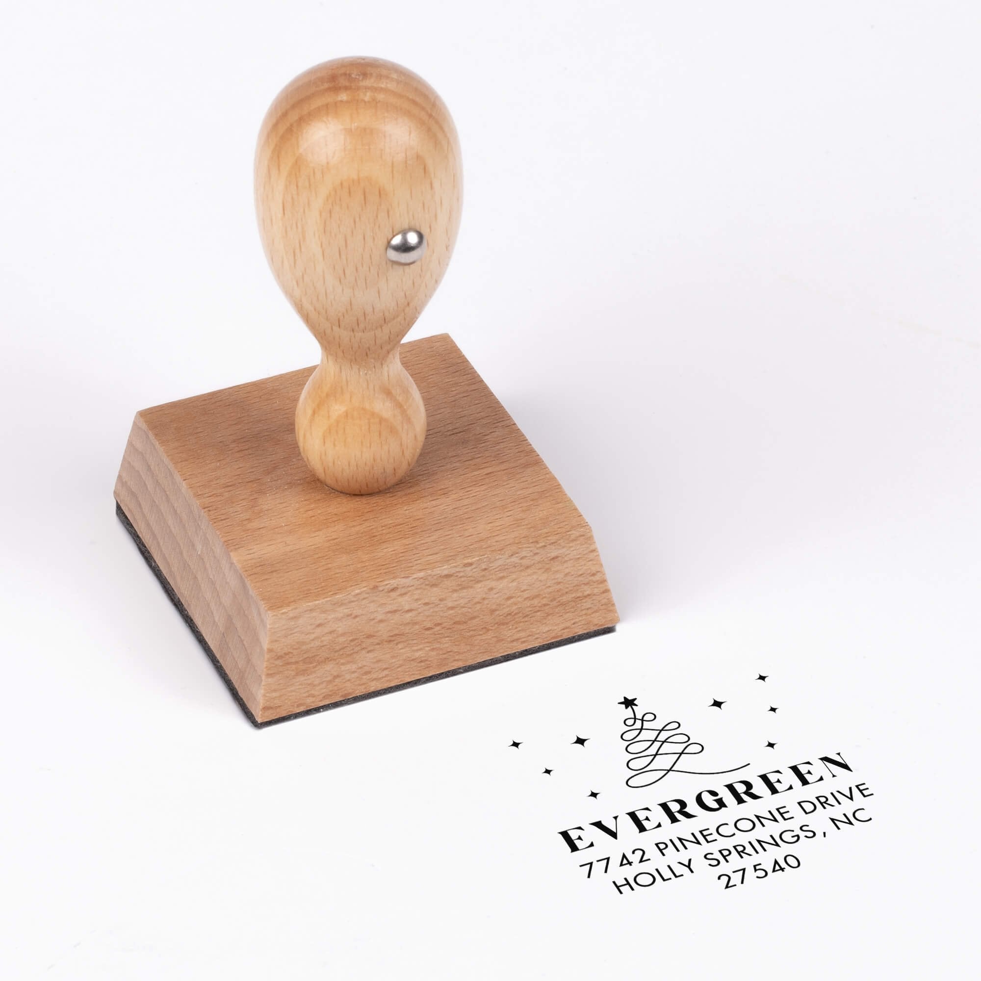 European wood hand stamp shown from above featuring custom ‘Modern Christmas Tree’ holiday return address design.