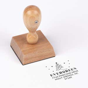 European wood hand stamp shown from above featuring custom ‘Modern Christmas Tree’ holiday return address design.