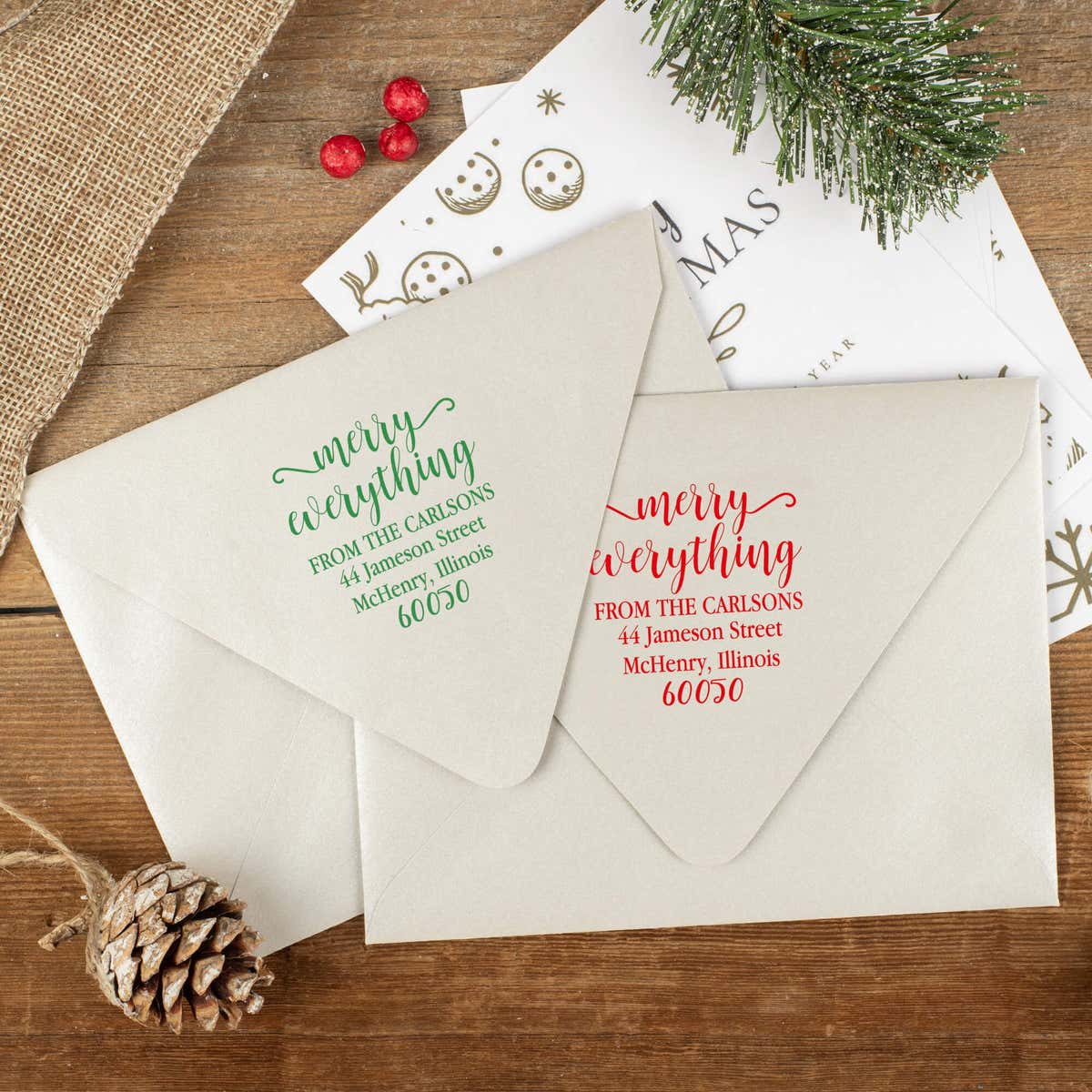 Green and red ink impressions of ‘Merry Everything’ return address stamp on Christmas envelopes.