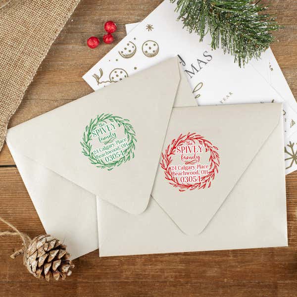 Green and red ink impressions of ‘Christmas Wreath Outline’ return address stamp on Christmas envelopes.