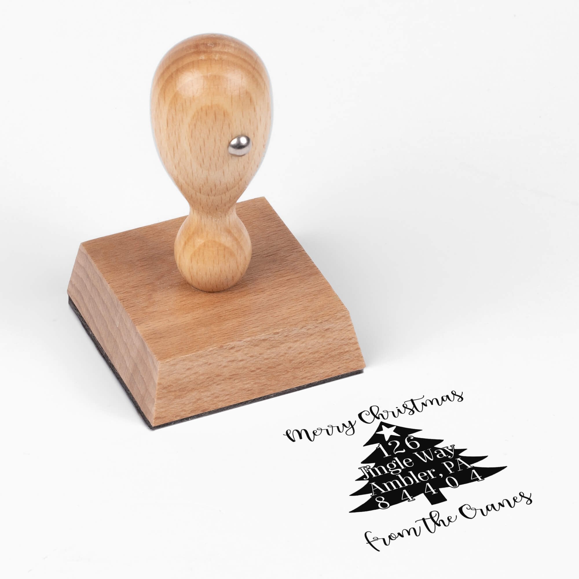 European wood hand stamp shown from above featuring custom ‘Christmas Tree’ holiday return address design.