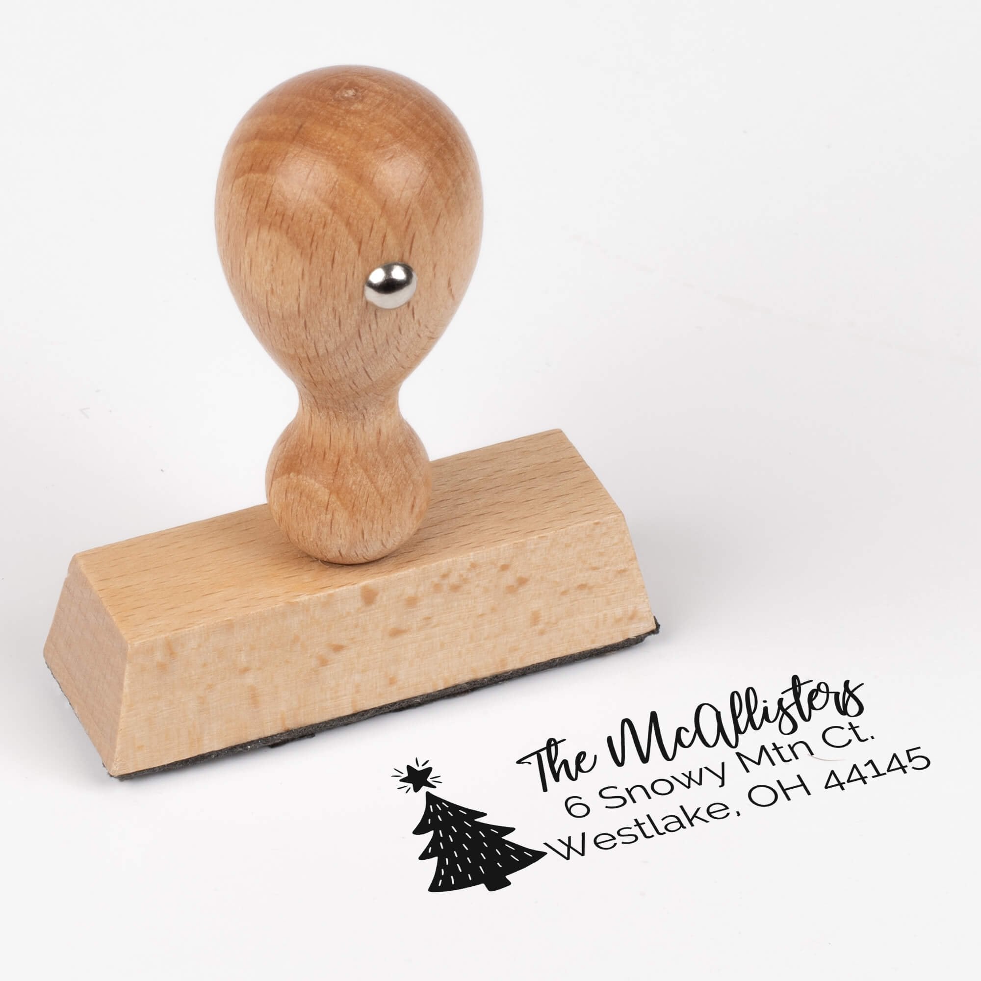 European wood hand stamp shown from above featuring custom ‘Christmas Tree Holiday’ holiday return address design.
