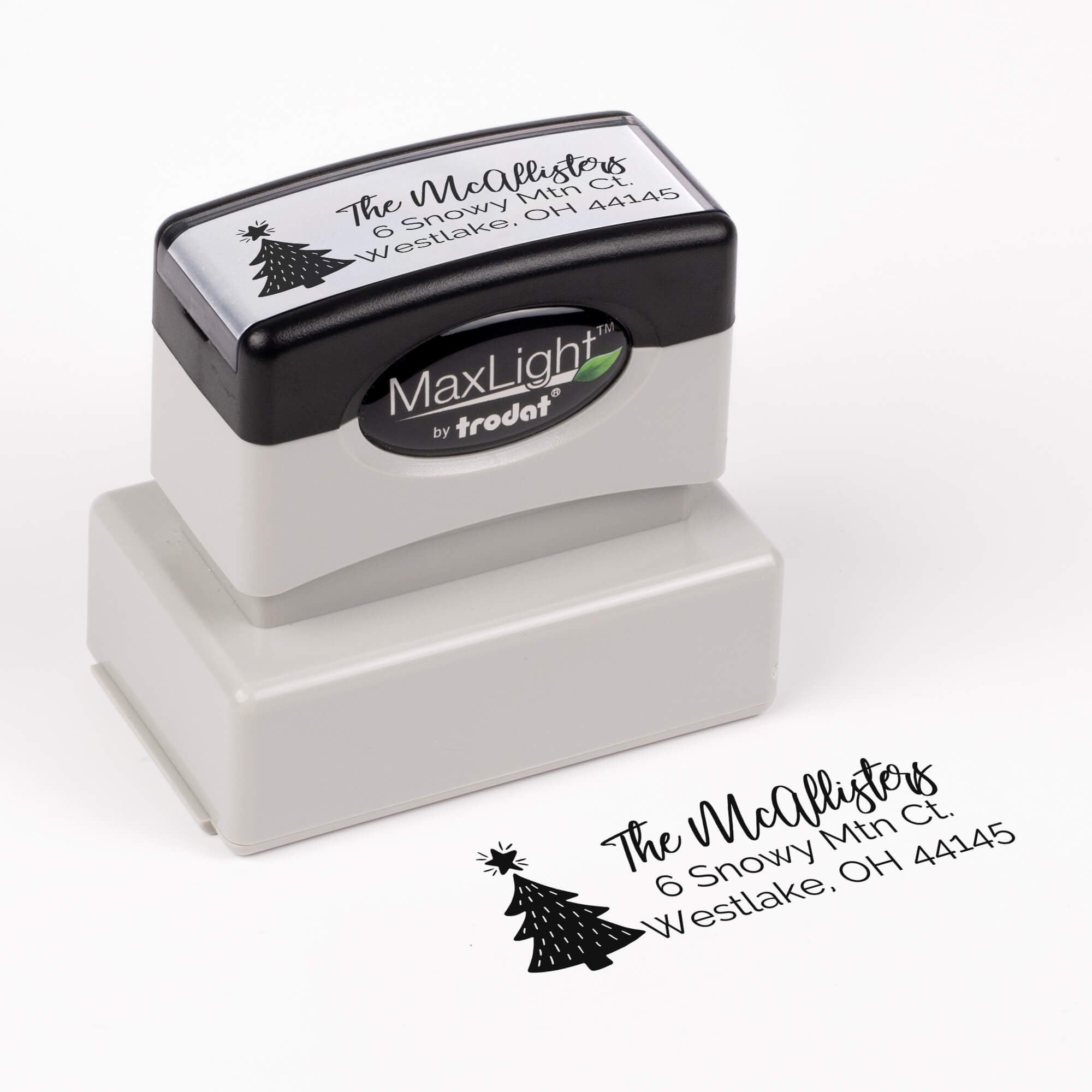 Pre-inked stamp shown from above featuring custom ‘Christmas Tree Holiday’  holiday return address design.