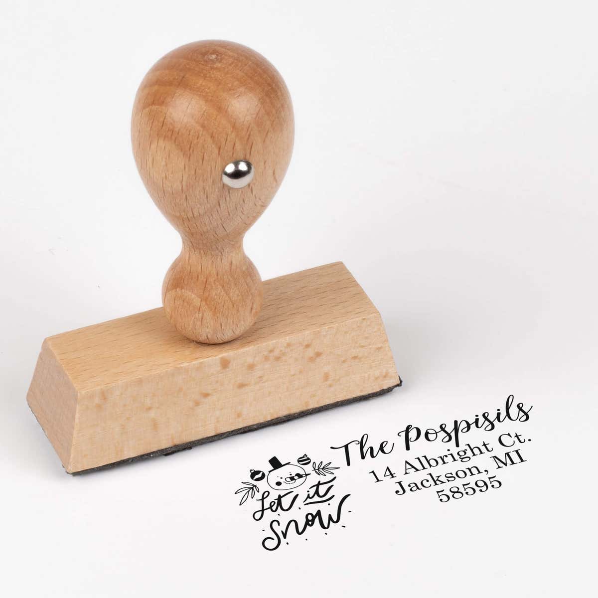 European wood hand stamp shown from above featuring custom ‘Let It Snow Winter Snowman’ holiday return address design.