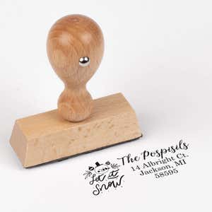 European wood hand stamp shown from above featuring custom ‘Let It Snow Winter Snowman’ holiday return address design.
