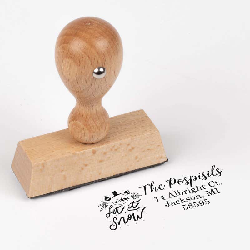 European wood hand stamp shown from above featuring custom ‘Let It Snow Winter Snowman’ holiday return address design.