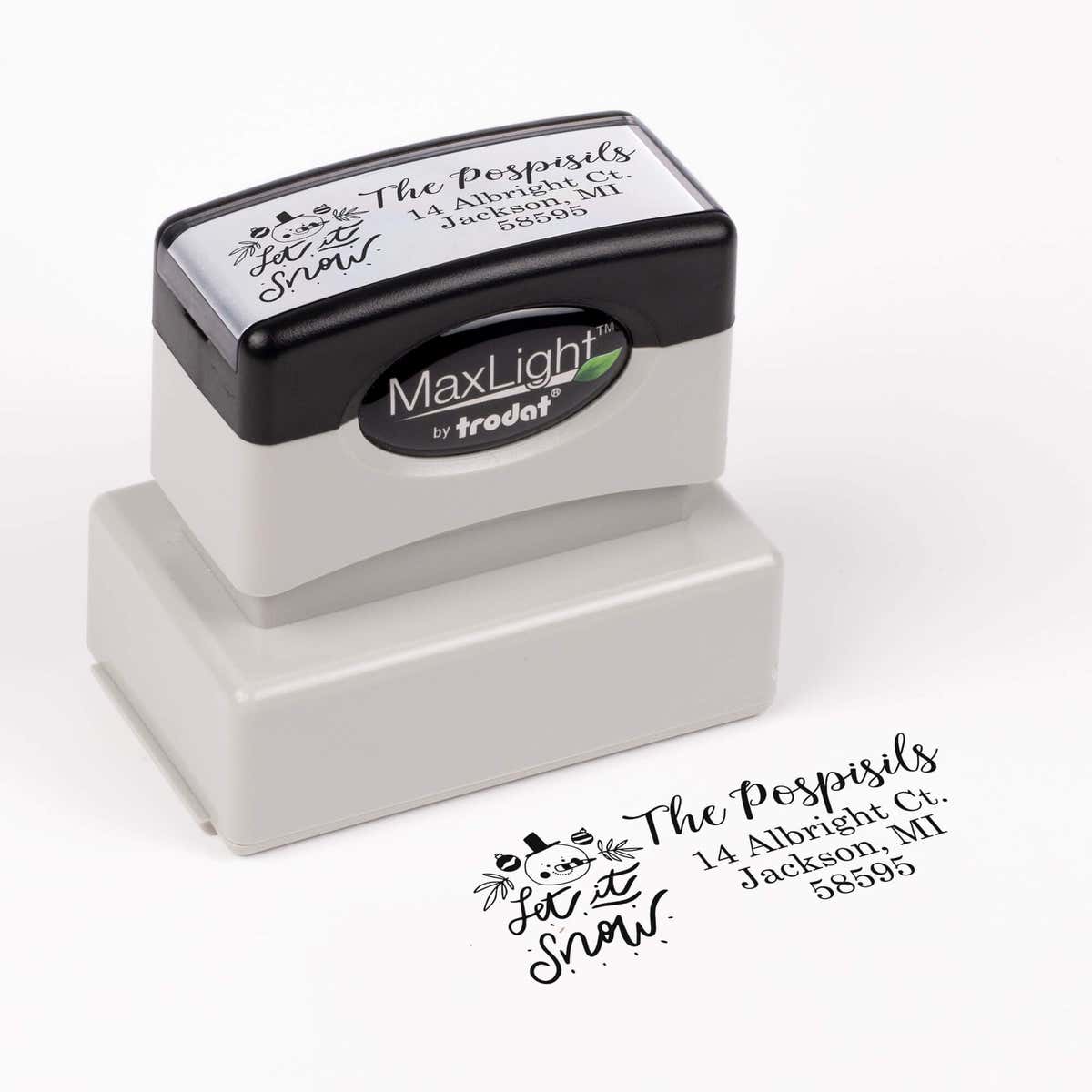 Pre-inked stamp shown from above featuring custom ‘Let It Snow Winter Snowman’  holiday return address design.