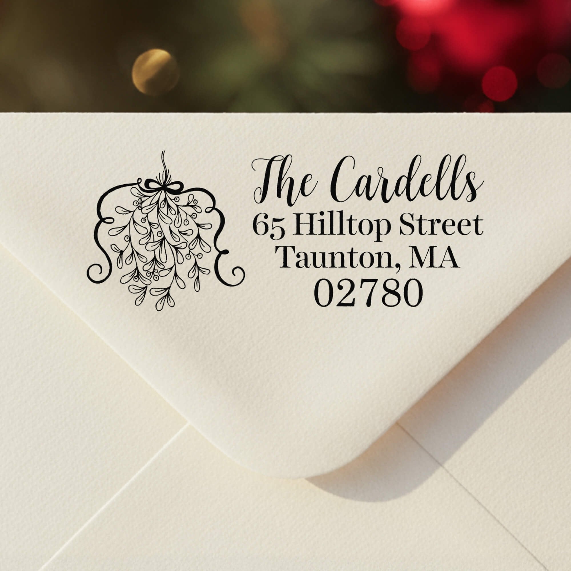 Personalized ‘Curly Mistletoe Holiday’ address stamp impression on envelope flap for holiday cards.