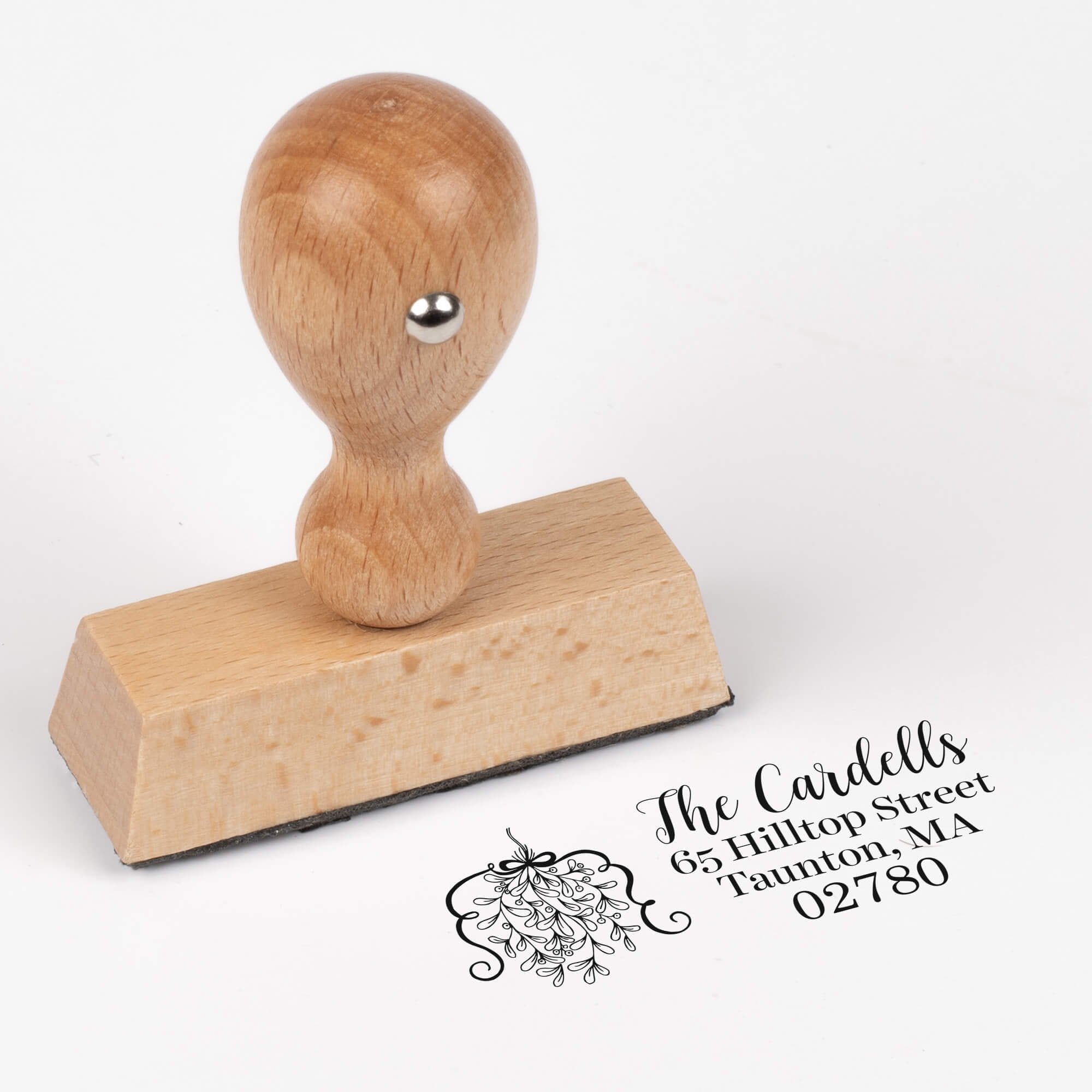European wood hand stamp shown from above featuring custom ‘Curly Mistletoe Holiday’ holiday return address design.