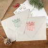 Green and red ink impressions of ‘HoHoHo Christmas’ return address stamp on Christmas envelopes.
