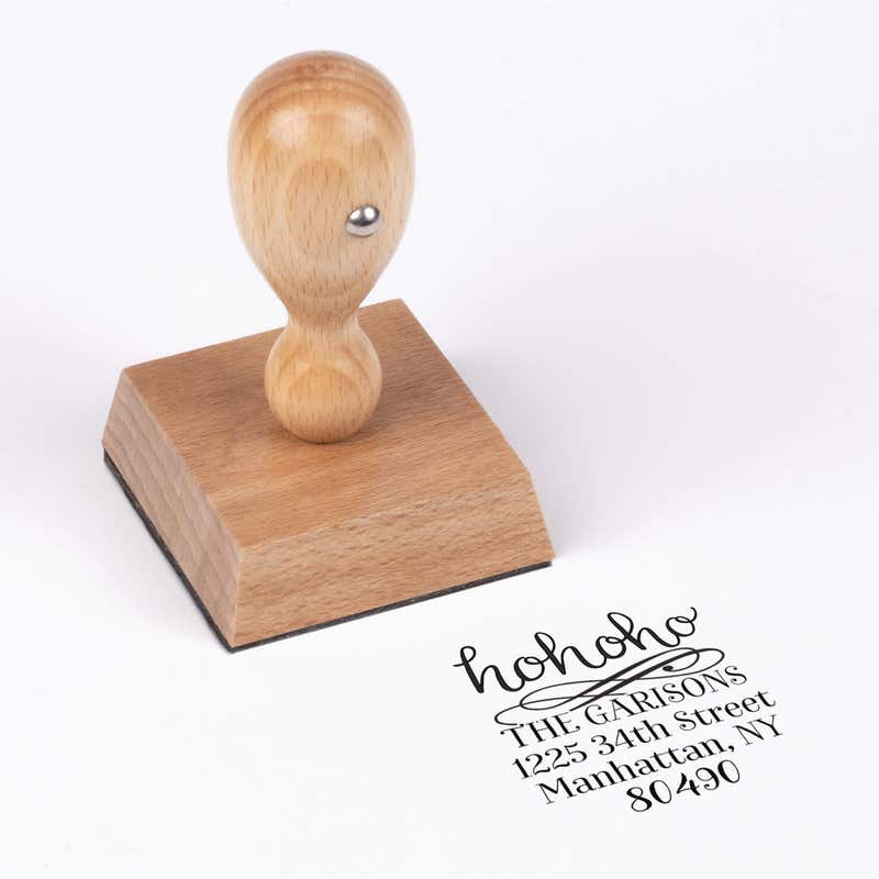European wood hand stamp shown from above featuring custom ‘HoHoHo Christmas’ holiday return address design.