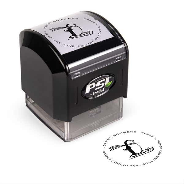 Pre-inked stamp shown from above featuring custom ‘Sledding Penguin Holiday’  holiday return address design.