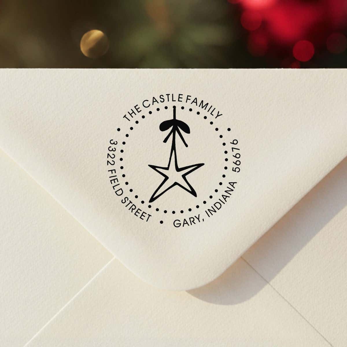 Personalized round ‘Holiday Star’ address stamp impression on envelope flap for holiday cards.