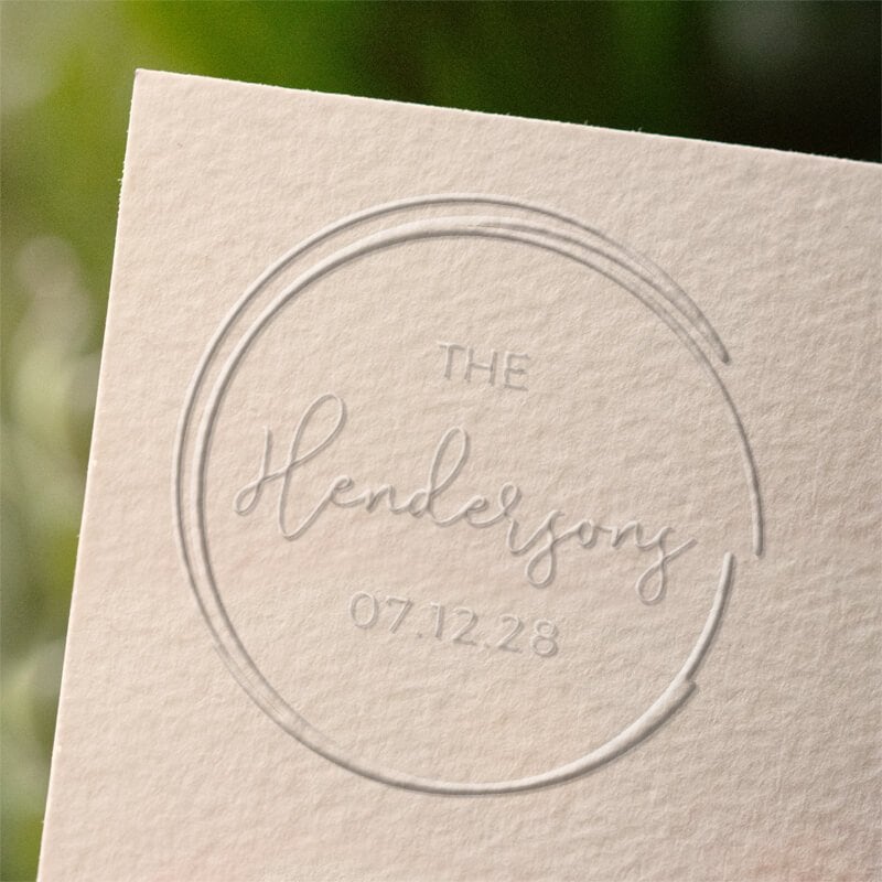 Circle swipe wedding embosser with example impression example on sheet of paper