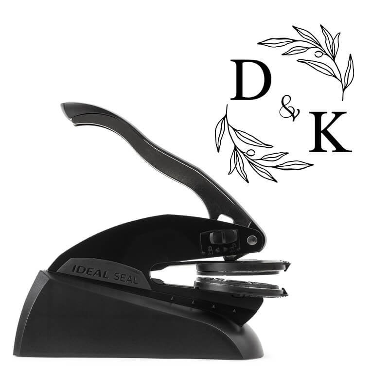 Professional black embosser shown beside a sample impression of the wedding design
