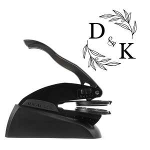 Professional black embosser shown beside a sample impression of the wedding design