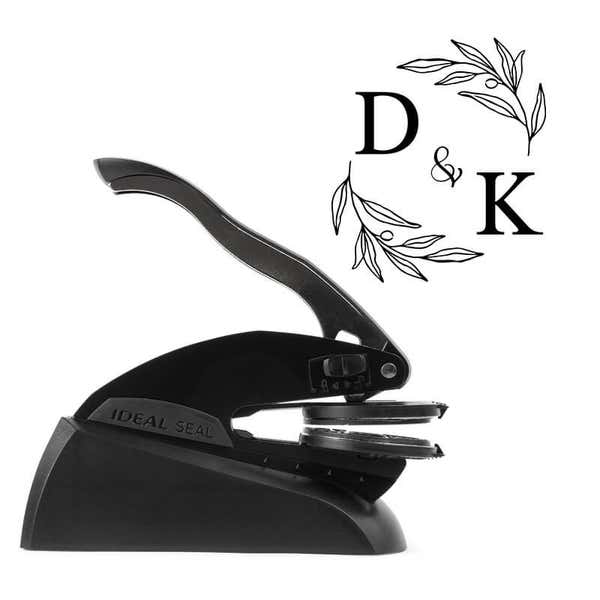 Professional black embosser shown beside a sample impression of the wedding design