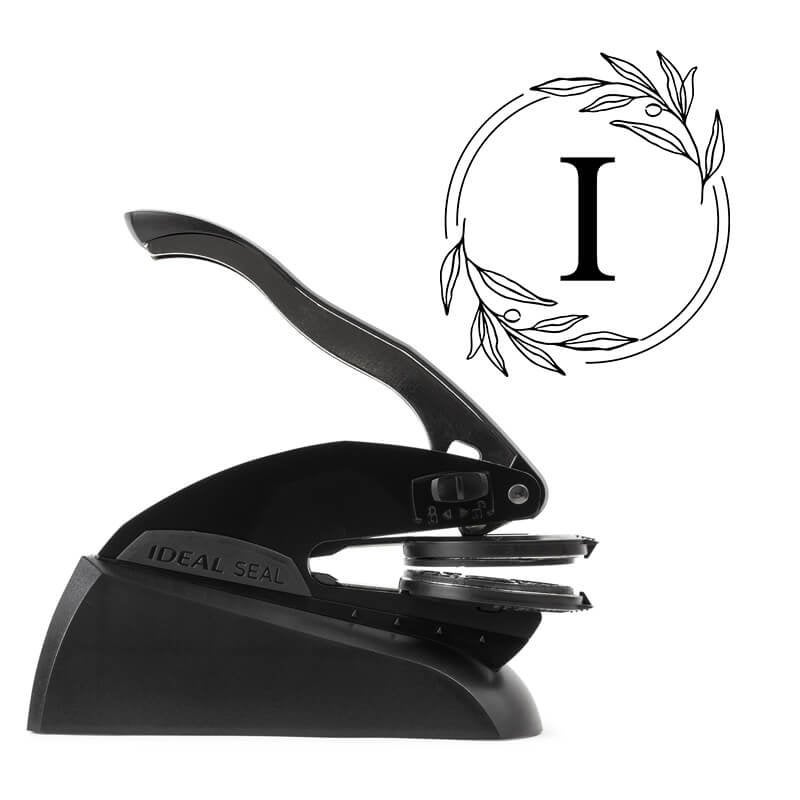 Professional black embosser shown beside a sample impression of the wedding design