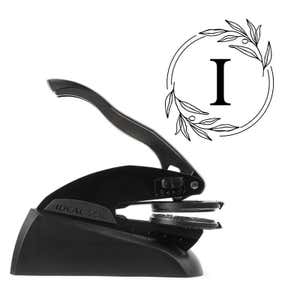Professional black embosser shown beside a sample impression of the wedding design