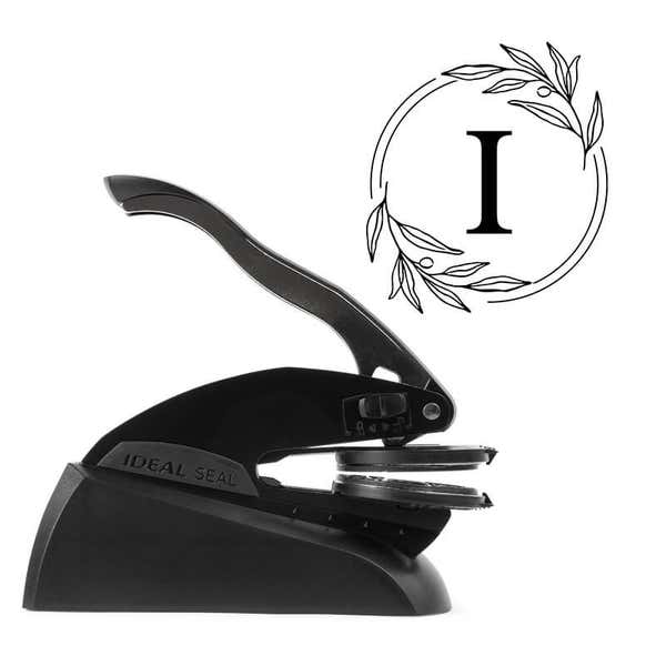 Professional black embosser shown beside a sample impression of the wedding design