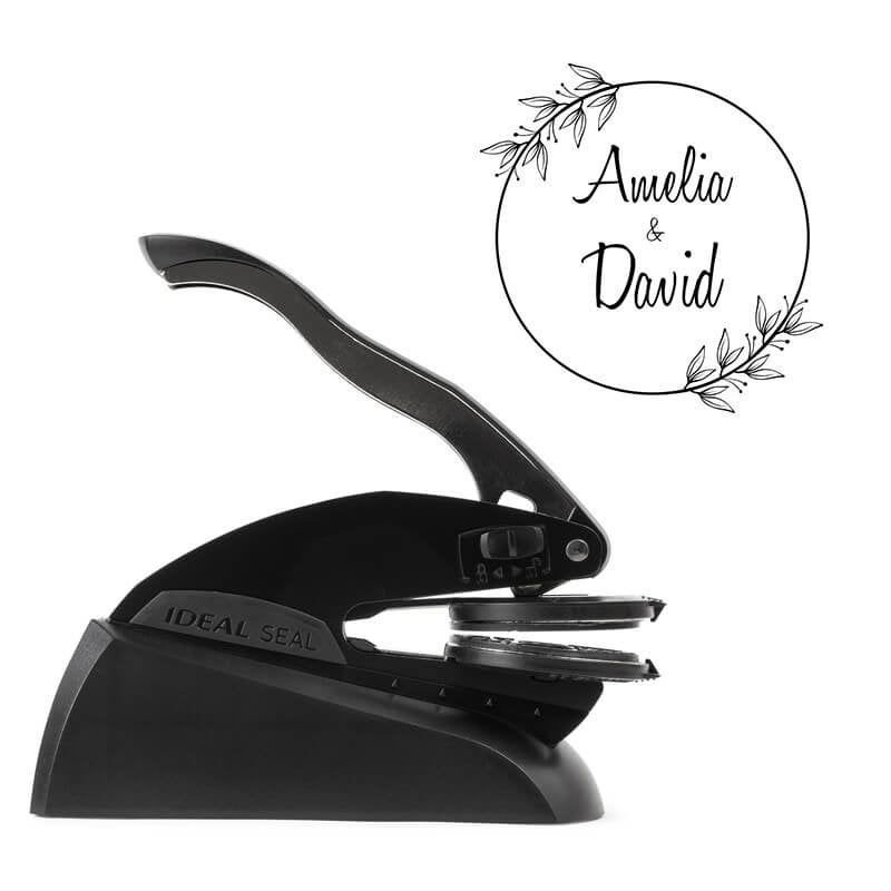 Side view of Ideal Seal custom embosser with sample wedding design shown beside it