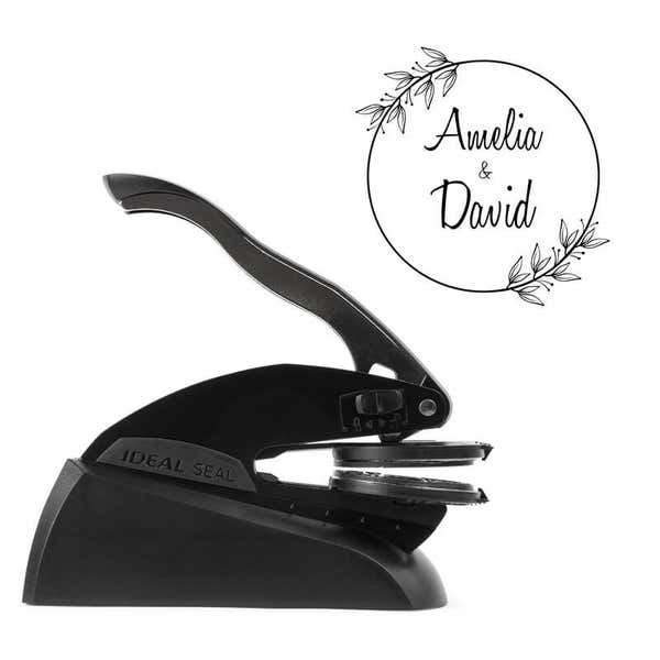 Side view of Ideal Seal custom embosser with sample wedding design shown beside it