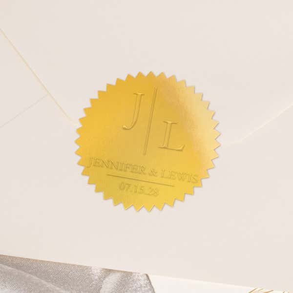 Close-up of gold foil seal with embossed design impression on the back of an envelope 