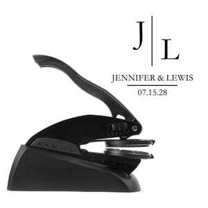 Professional black embosser shown beside a sample impression of the wedding design