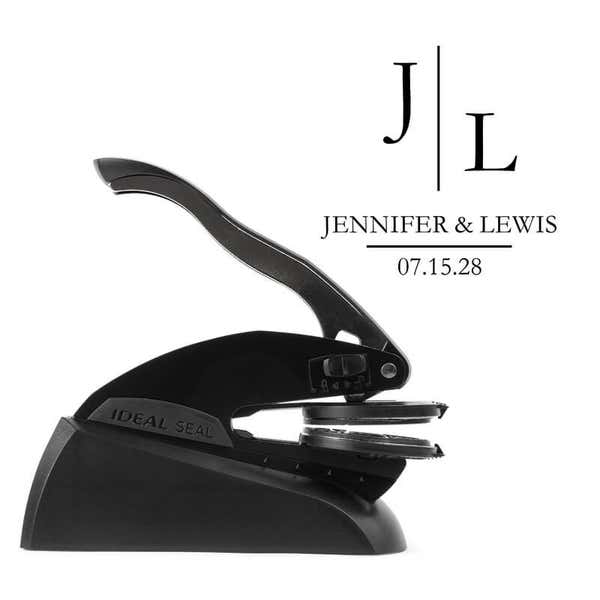 Professional black embosser shown beside a sample impression of the wedding design