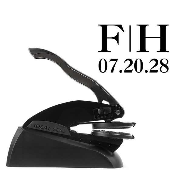 Professional black embosser shown beside a sample impression of the wedding design