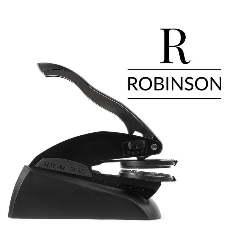 Professional black embosser shown beside a sample impression of the wedding design