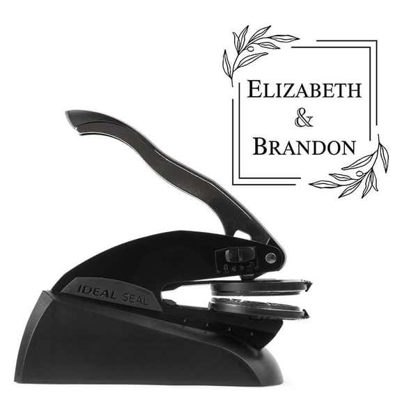 Professional black embosser shown beside a sample impression of the wedding design