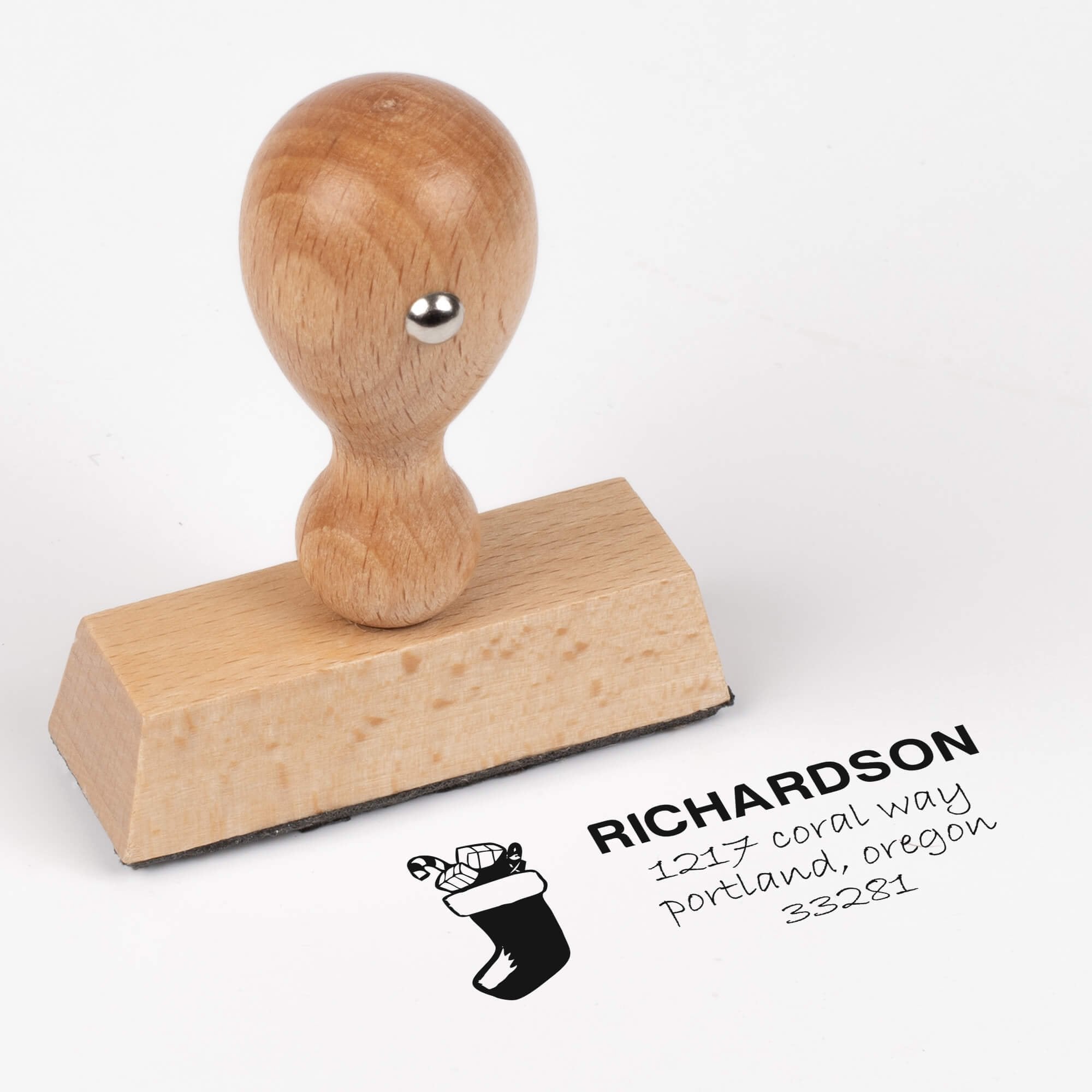 European wood hand stamp shown from above featuring custom ‘Richardson Stocking’ holiday return address design.