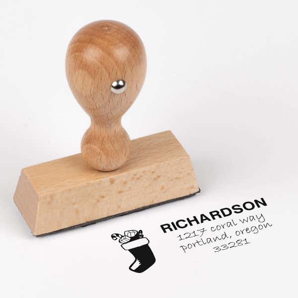 European wood hand stamp shown from above featuring custom ‘Richardson Stocking’ holiday return address design.