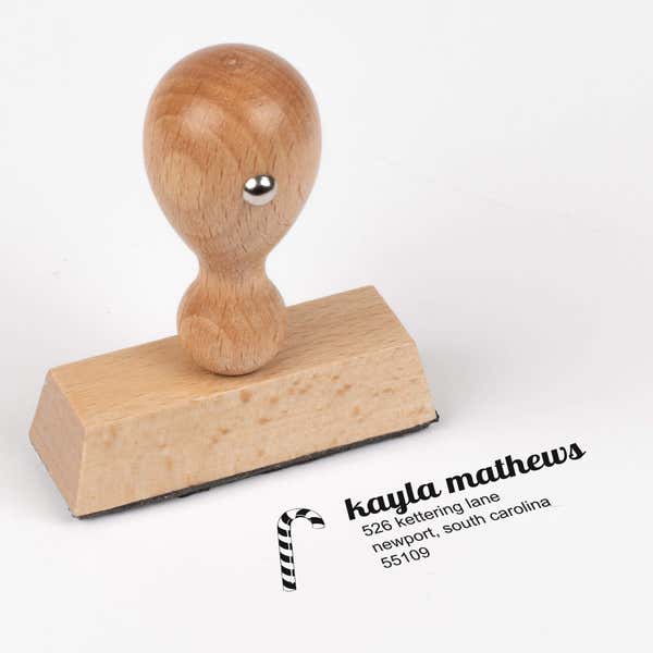 European wood hand stamp shown from above featuring custom ‘Mathews Candy Cane’ holiday return address design.