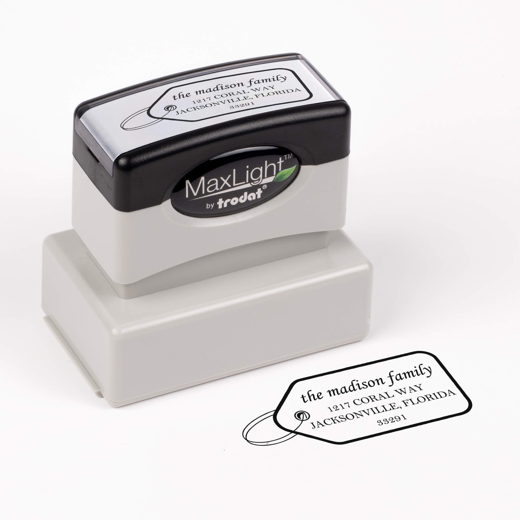 Pre-inked stamp shown from above featuring custom ‘Madison Gift Tag’  holiday return address design.