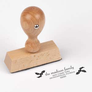 European wood hand stamp shown from above featuring custom ‘Madison Holly’ holiday return address design.