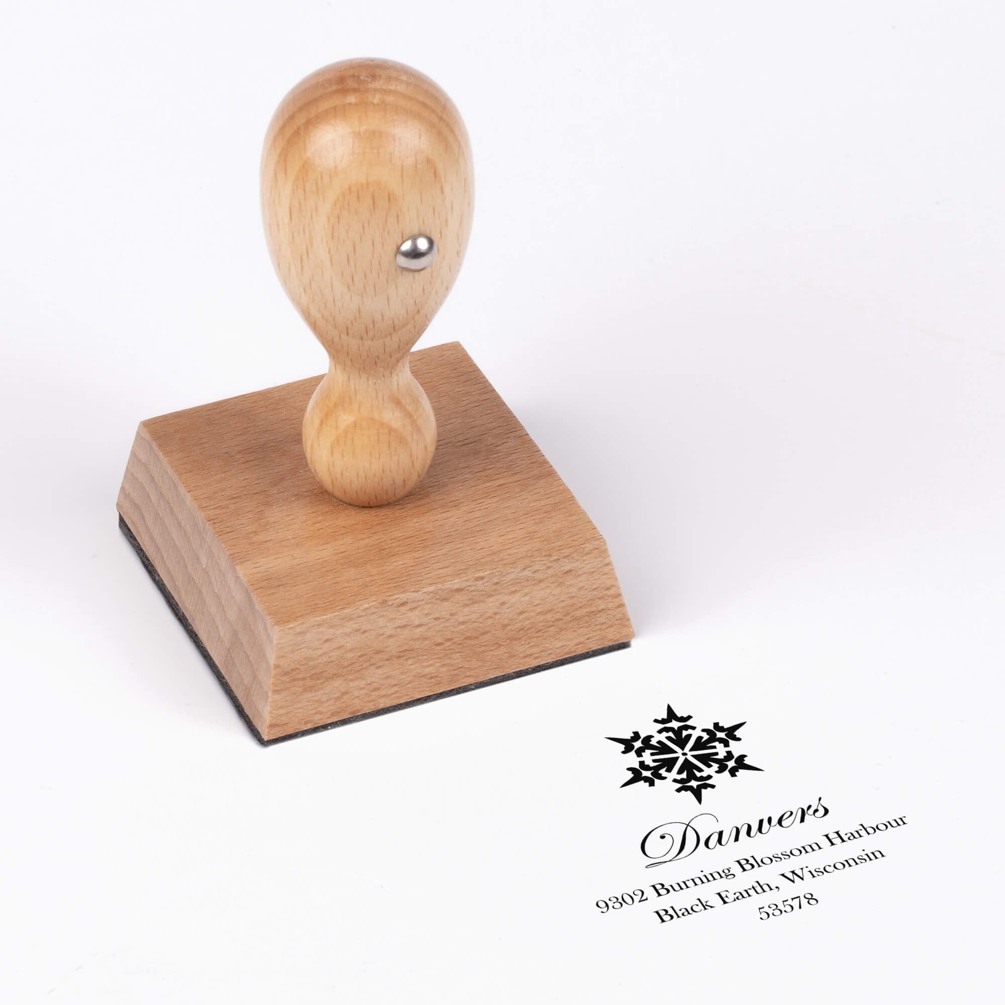 European wood hand stamp shown from above featuring custom ‘Danvers Snowflake’ holiday return address design.