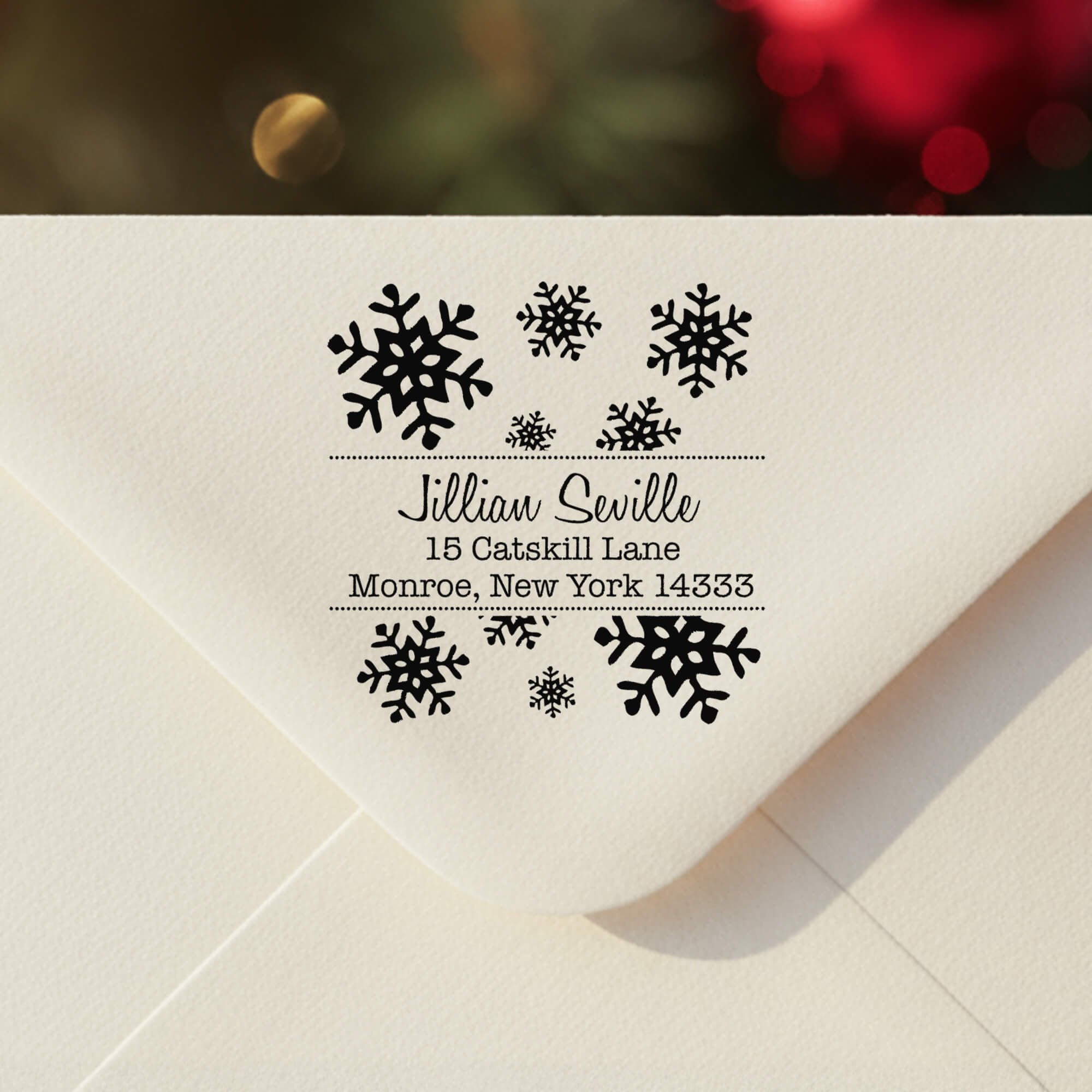 Personalized ‘Seville Snowflakes’ address stamp impression on envelope flap for holiday cards.